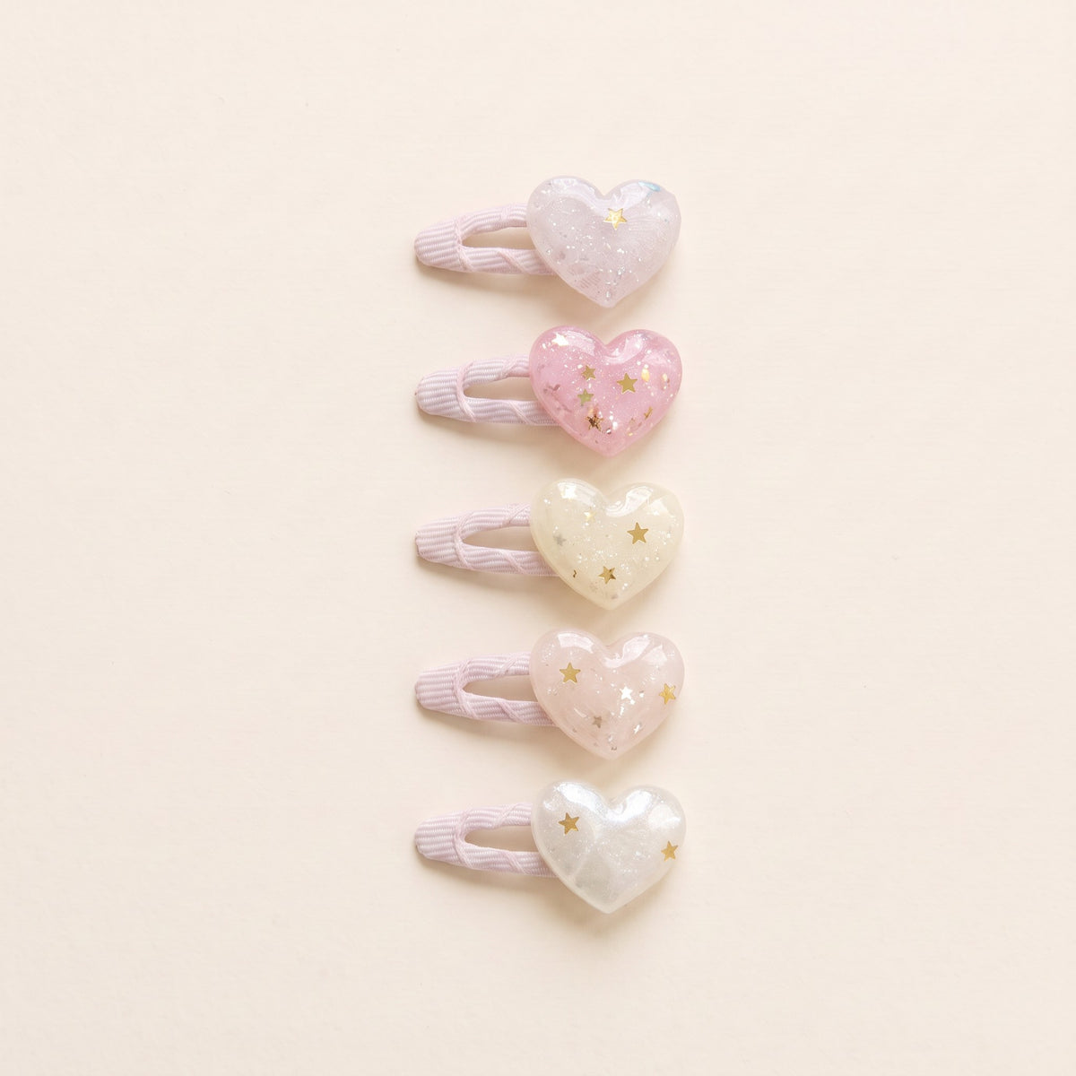 Five glitter heart tic tac clips in pale pink, pink, cream, blush and pearly white