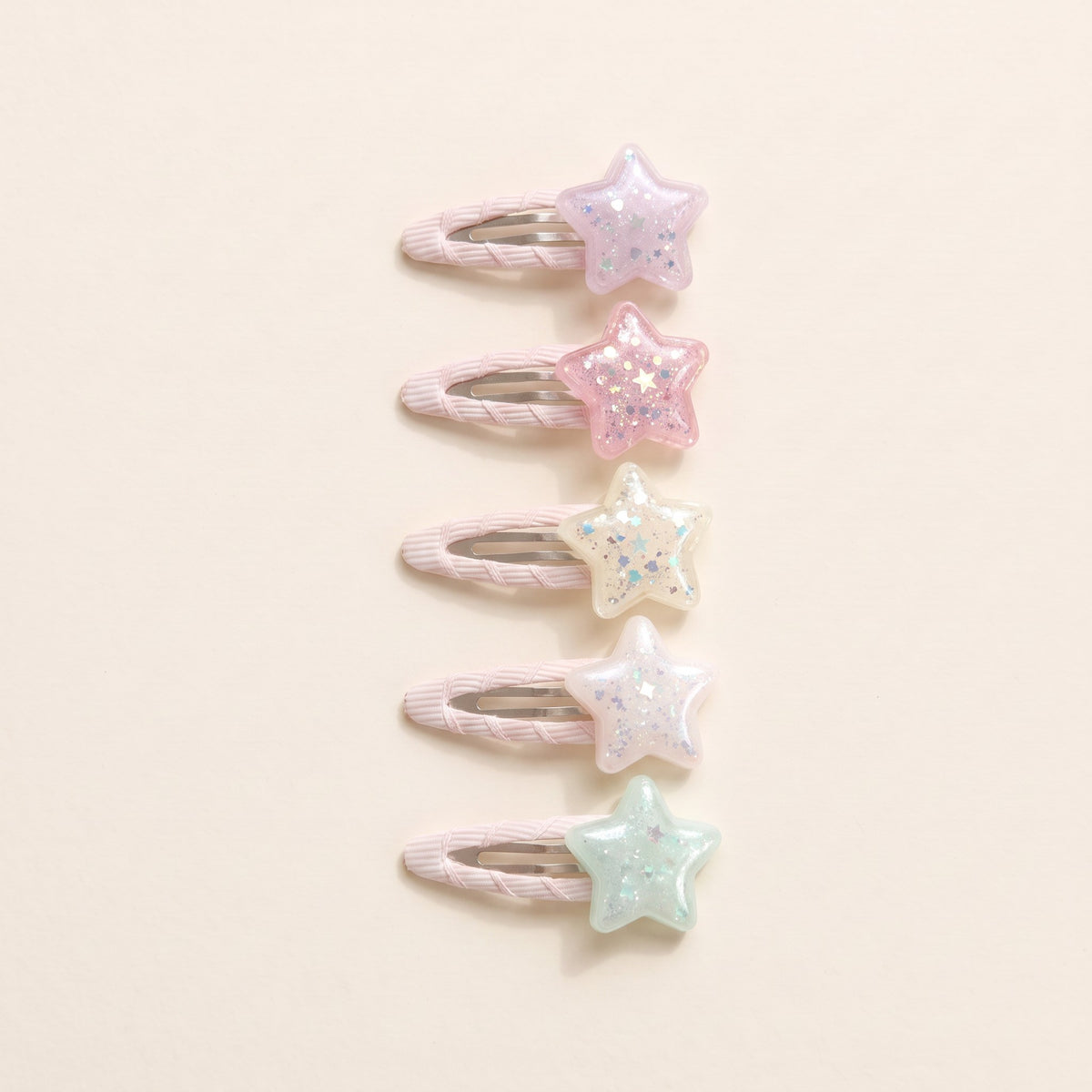 Five glitter star tic tac clips in pale pink, pink, cream, blush and pearly white