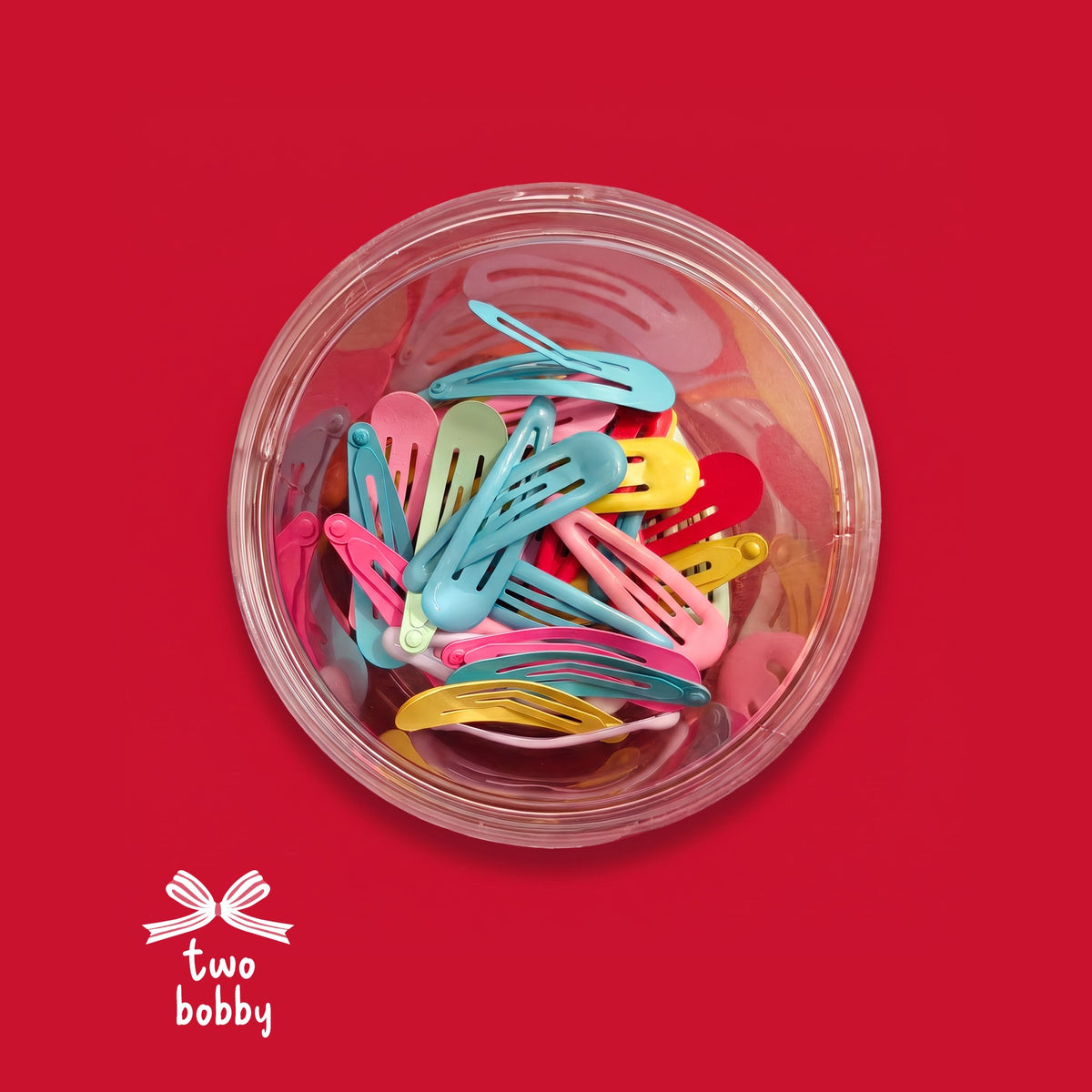 Multicolored Tic Tacs box of 30 on a red background with the two bobby logo
