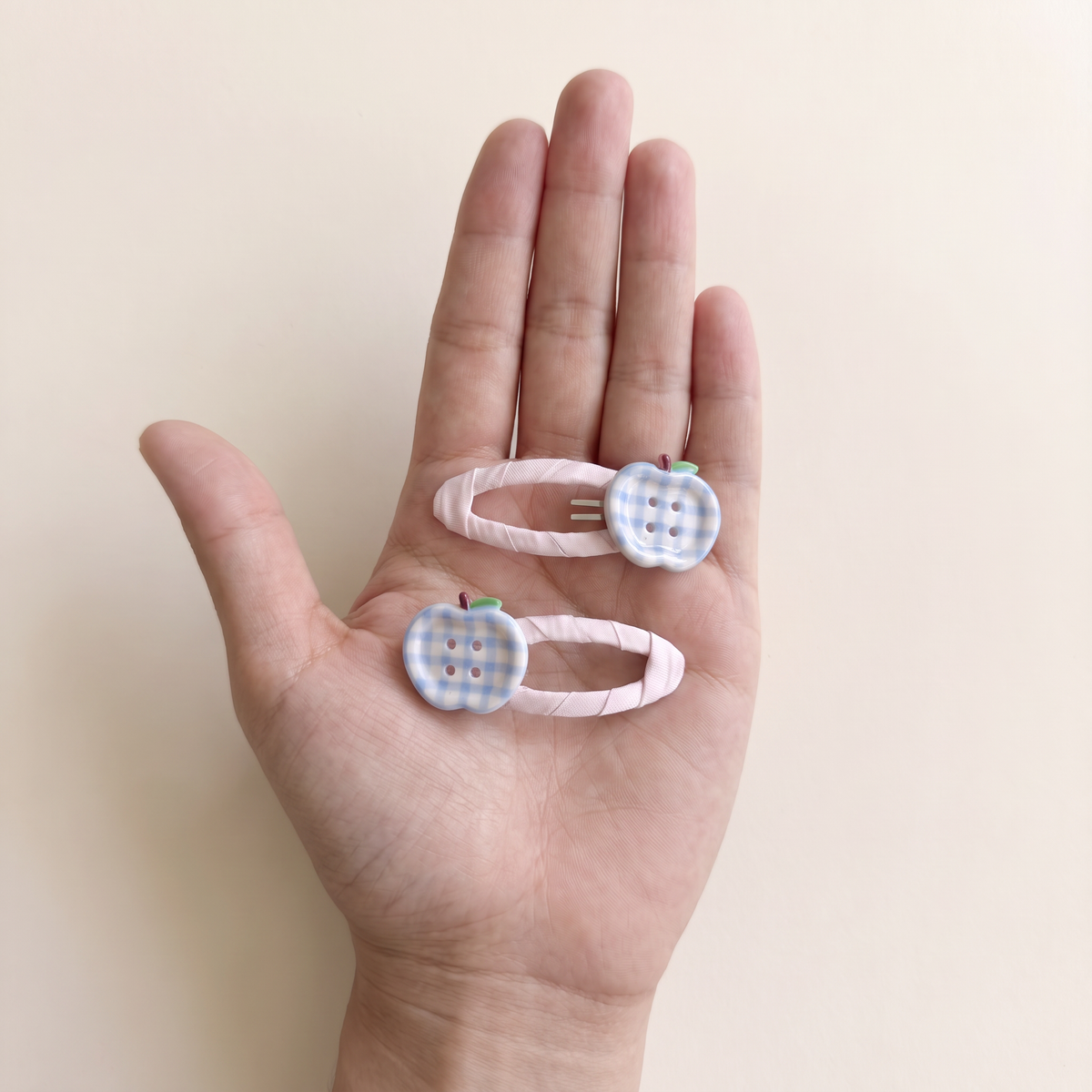 two bobby Gingham Apple Snap Clips – Pink, size in hand