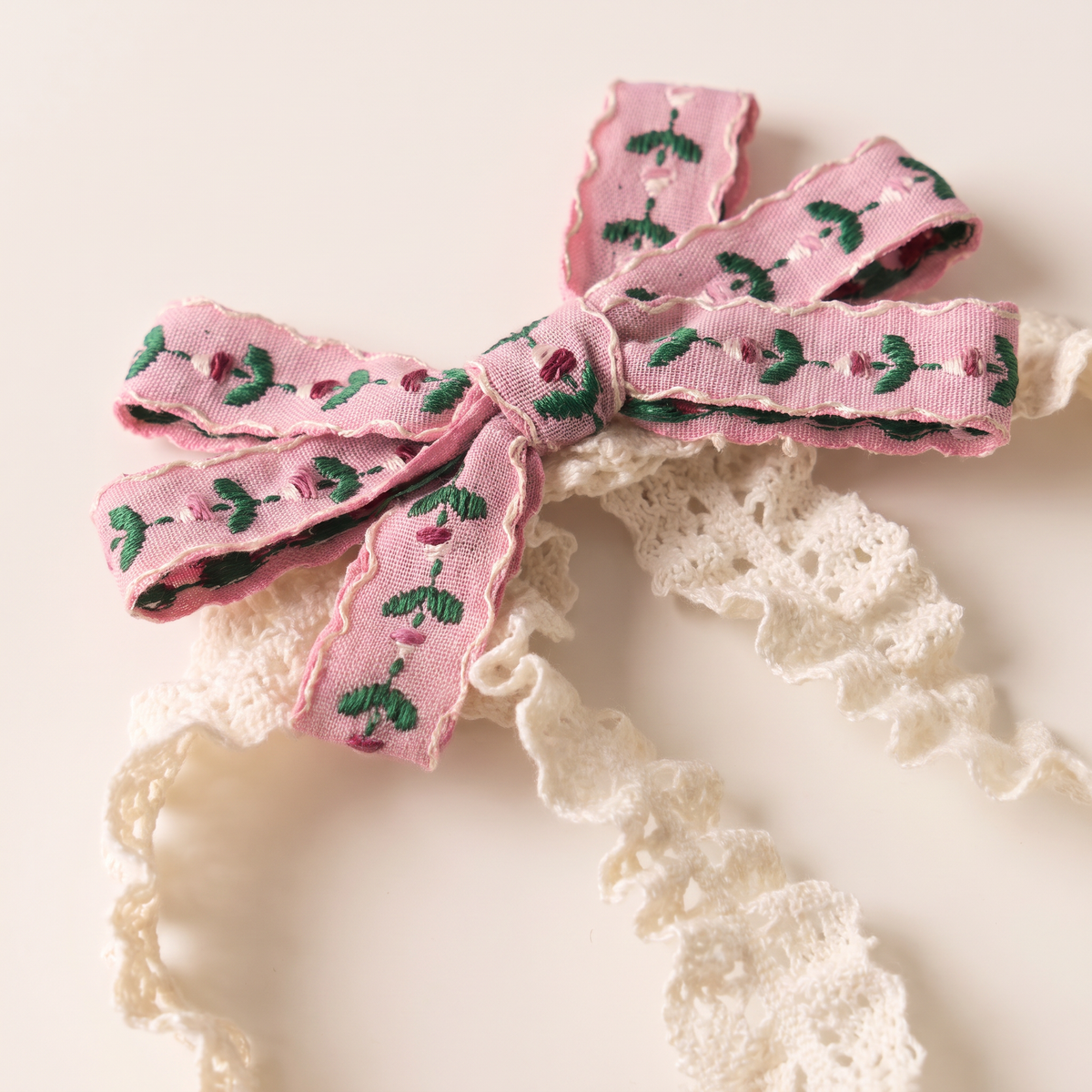 two bobby Embroidered Floral Lace Headband – Pink, bow and lace close-up