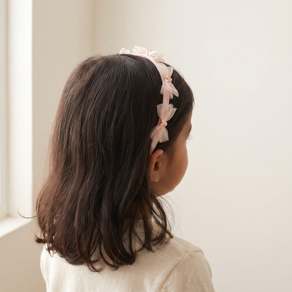 two bobby Tulle Bow Grip Headband – Pink, worn