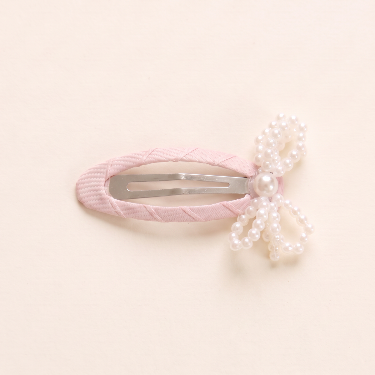 two bobby Mini Pearl Bow Snap Clips, snap clip and pearl bow close-up