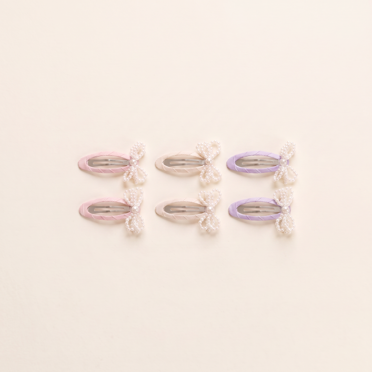 two bobby Mini Pearl Bow Snap Clips - all three colours