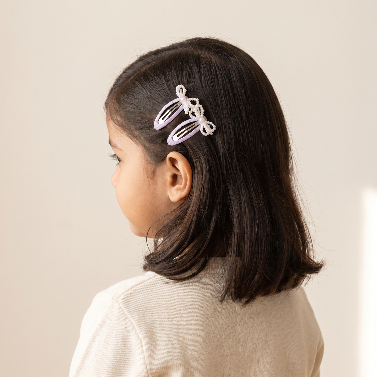 two bobby Mini Pearl Bow Snap Clips – Lavender, worn