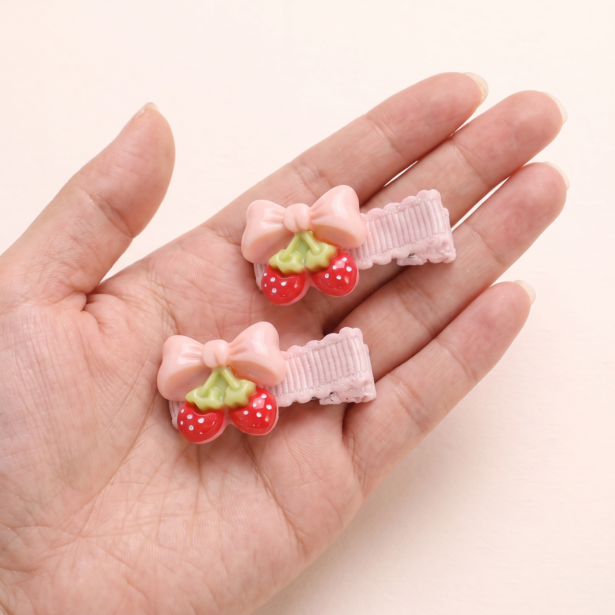 two bobby Fruit Charm Bow Clips – One pair in hand, for size