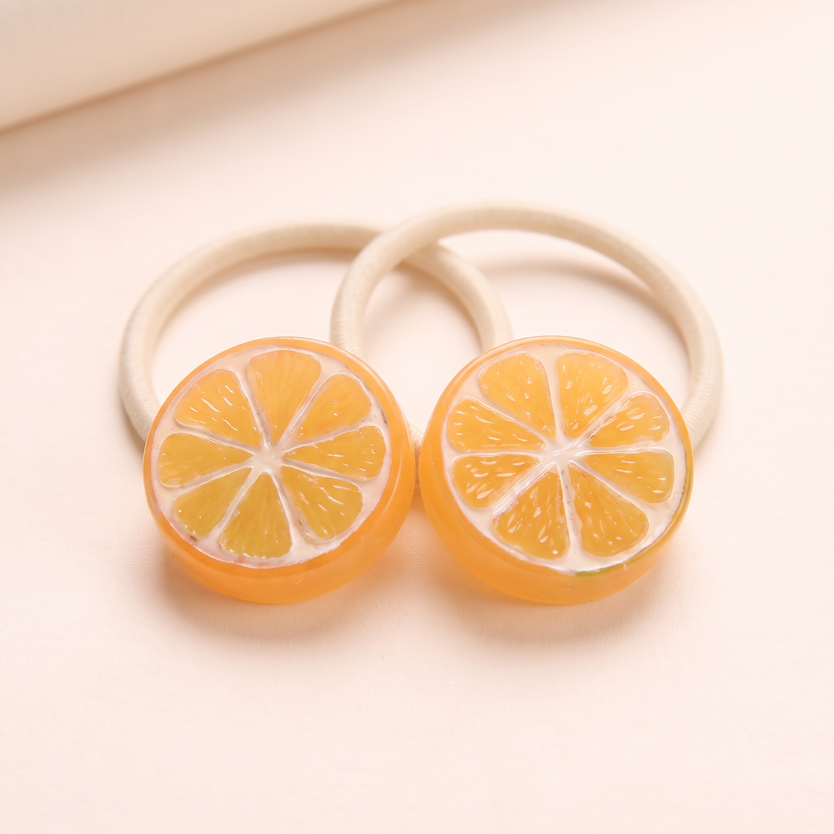 two bobby Fruit Slice Hair Ties – Close-up of one pair