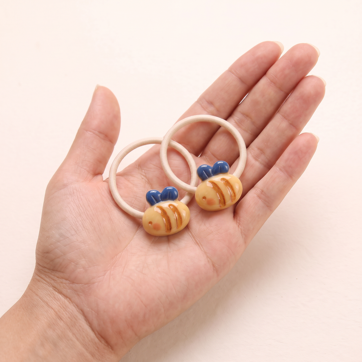 two bobby Garden Friends Hair Ties – One pair in hand, for size