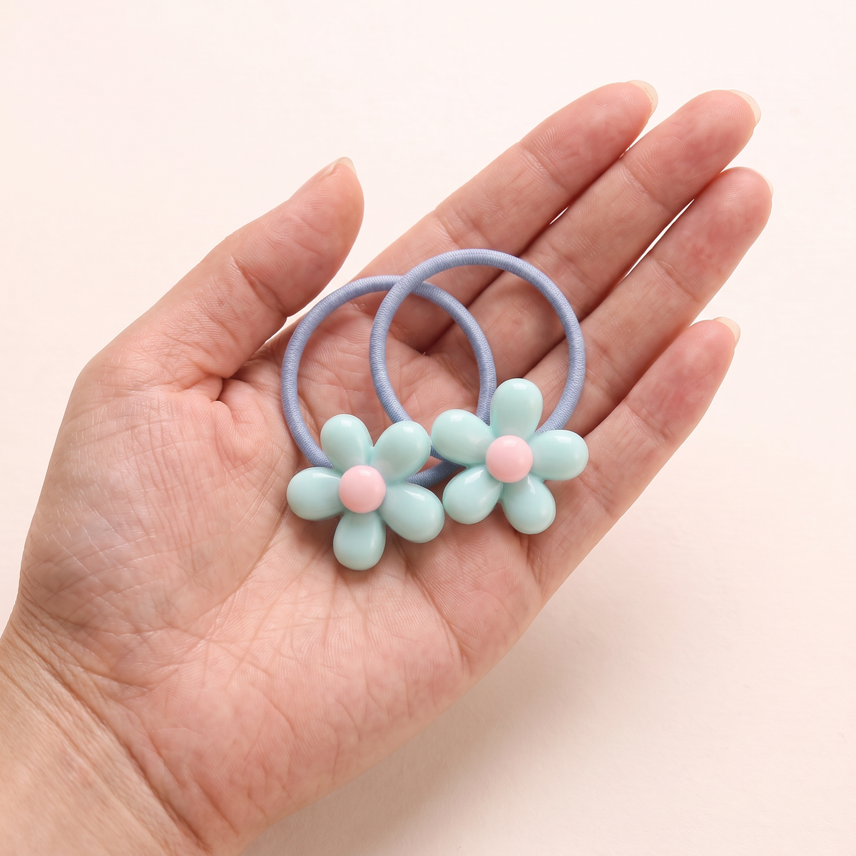 two bobby Matte Daisy Hair Ties – One pair in hand, for size