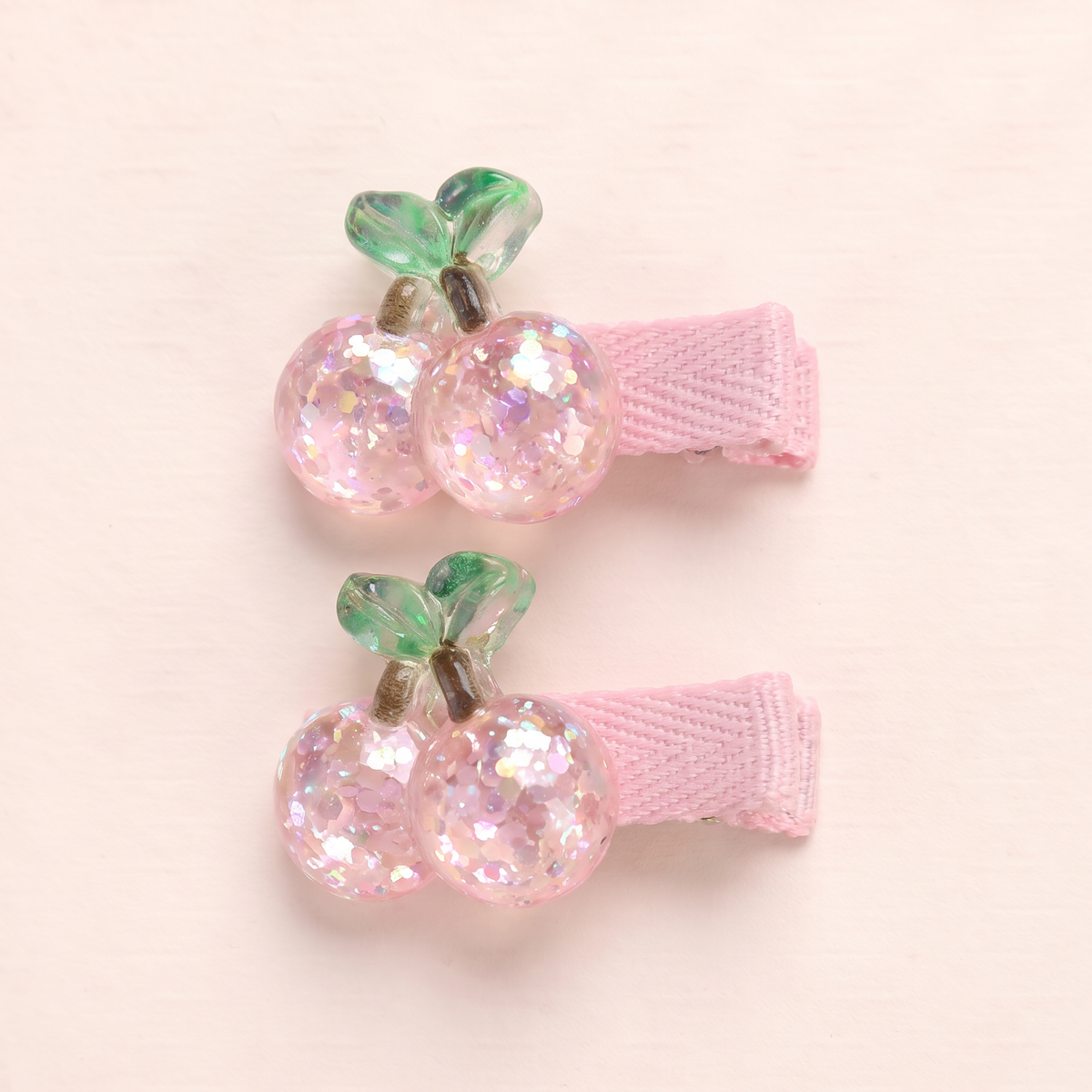 two bobby Glitter Cherry Clips – Close-up of one pair