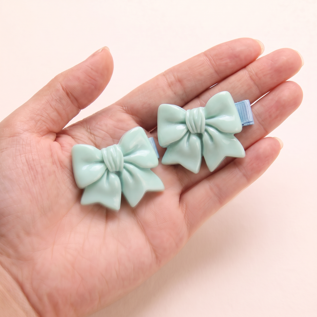 two bobby Glossy Bow Clips – One pair in hand, for size