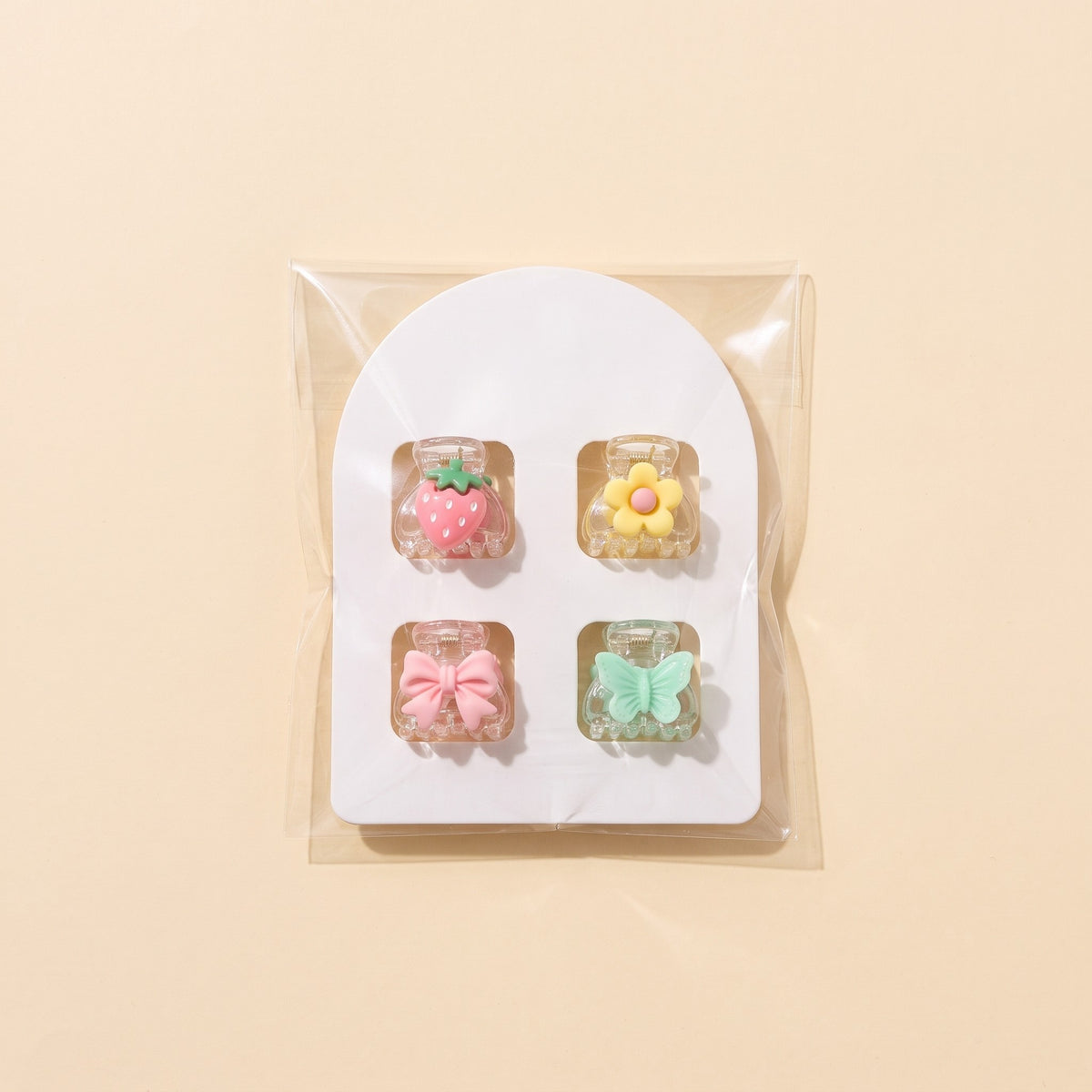 One card of 4 charm mini claw clips as it ships