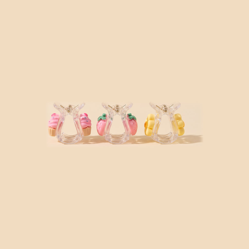 Three charm mini claw clips from the side, the same charm on both jaws