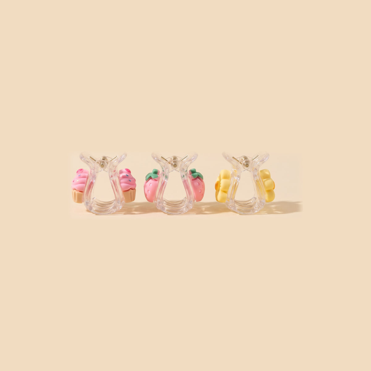 Three charm mini claw clips from the side, the same charm on both jaws