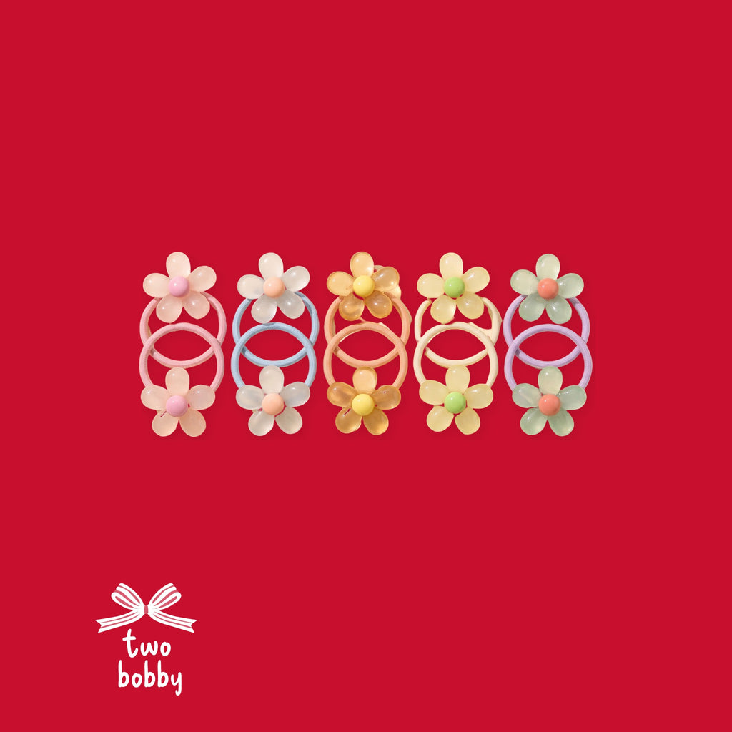 All 5 jelly daisy hair tie colours on two bobby red